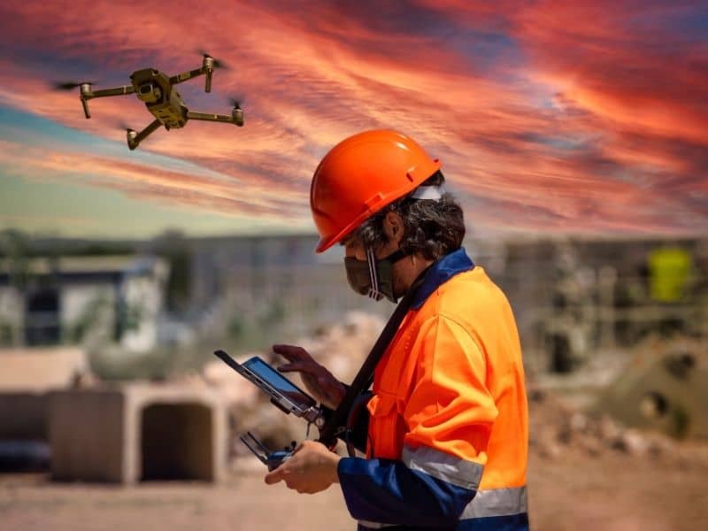 Drone operator performing LiDAR mapping over a large development site to capture terrain data for planning and engineering analysis.