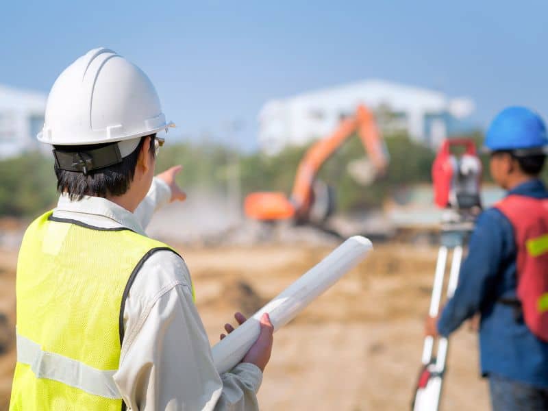 Construction surveyor performing site layout for a building project in Kansas City Missouri
