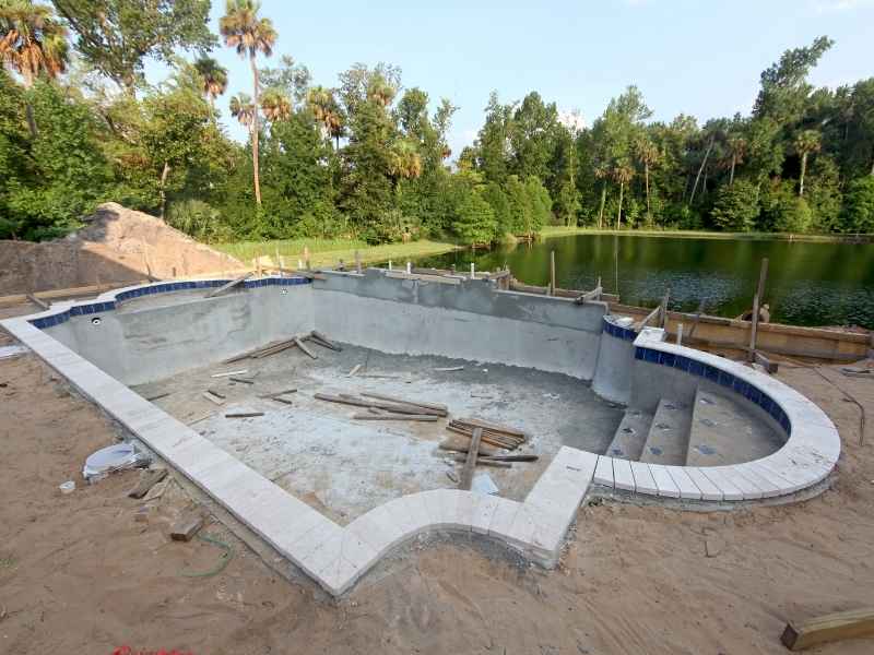 Pool construction site showing grading conditions and elevation planning before completion in Kansas City Missouri
